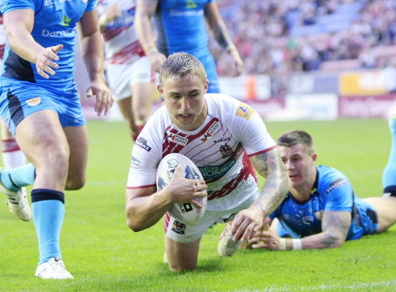 Powell goes over for a try against Hull FC at the DW Stadium in 2014.