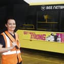 Dr Helen Wall, Bolton GP and clinical director of population health at NHS Greater Manchester, next to a bus featuring the winter vaccination campaign at a depot in Ashton