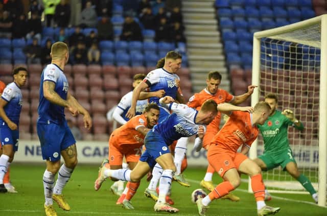 Charlie Wyke makes his presence felt in the box against Blackpool