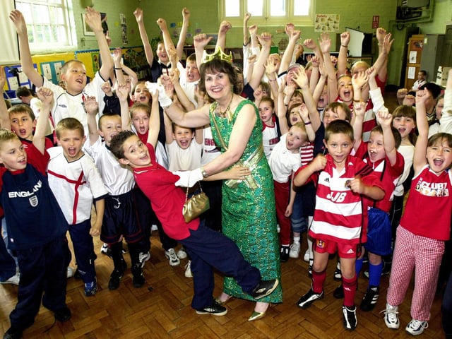 Tyan Sumner, aged 8, has a royal rumba with her majesty, alias school cleaner Margaret Bradley, at St. John's Primary School, New Springs, Queens Golden Jubilee celebrations on Thursday 30th of May 2002.