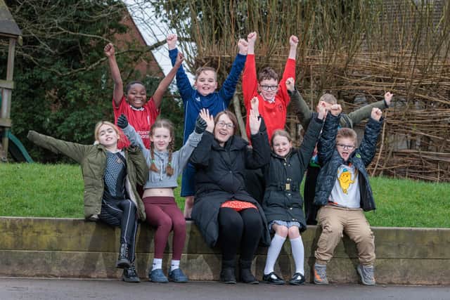 St Paul's CE Primary School Teacher Clare Cash with pupils Teegan, Emmanuel, Taiya, Ellis, Hayden, Holly, Dominic and Roman inside the area of playground to be developed.