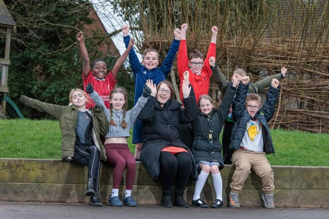 St Paul's CE Primary School Teacher Clare Cash with pupils Teegan, Emmanuel, Taiya, Ellis, Hayden, Holly, Dominic and Roman inside the area of playground to be developed.