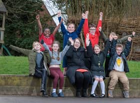 St Paul's CE Primary School Teacher Clare Cash with pupils Teegan, Emmanuel, Taiya, Ellis, Hayden, Holly, Dominic and Roman inside the area of playground to be developed.