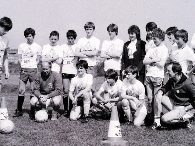 Manchester United soccer legend Bobby Charlton encourages youngsters during his summer soccer school in Wigan