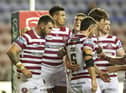 Wigan Warriors produced a victory over Catalans Dragons on Friday night