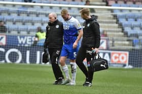 Jack Whatmough is helped from the field after damaging a knee against Norwich