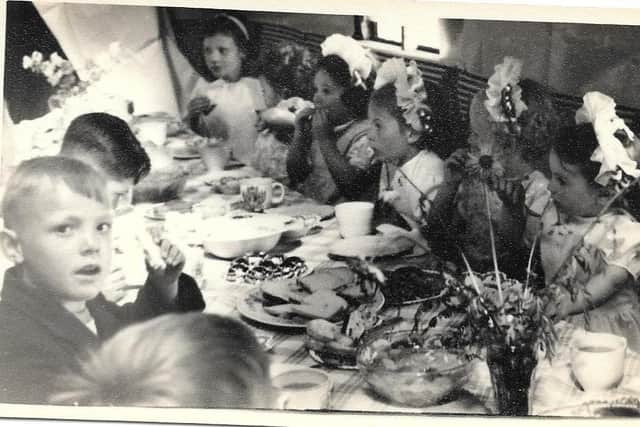 Tucking in: Kenneth Tidmarsh (looking at camera) with (right to left) five girls including Dianne Pilkington, Barbara Johnson and Eileen Topping.