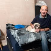 Michael Green, who sleeps in a damp and mouldy room, with his dog Milly