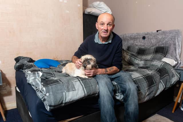 Michael Green, who sleeps in a damp and mouldy room, with his dog Milly