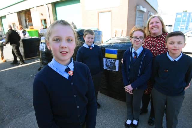 Pupils from the School Council at Orrell St James's RC primary school join staff at BA Berry Builders at Hewitt Business Park, Orrell, to help pack and load the food and items donated to send to Ukraine, from left, Amber Shaw, ten, Ronnie Hayes, ten, Emily Taberner,11, deputy head Julie Hayes and Olly Sibbit, 11.