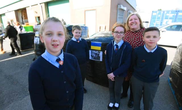 Pupils from the School Council at Orrell St James's RC primary school join staff at BA Berry Builders at Hewitt Business Park, Orrell, to help pack and load the food and items donated to send to Ukraine, from left, Amber Shaw, ten, Ronnie Hayes, ten, Emily Taberner,11, deputy head Julie Hayes and Olly Sibbit, 11.
