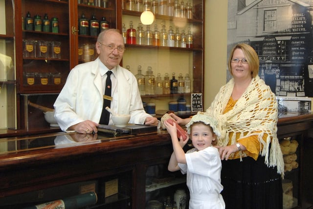 Volunteer Gordon Medlicott hands over a sponge and some carbolic soap to visitors Jessica Massey and her mum Julie in Kelletts Chemist.  The original chemists in Market Place, was run by Mr Kellett who was the Mayor in 1902/2 and who went to the coronation of Edward VII.