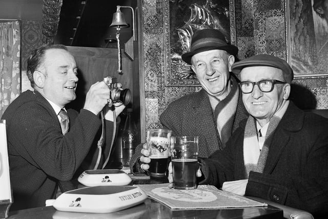 Landlord of the Victoria Hotel on Liverpool Road, Platt Bridge, John Lyon, takes a picture of regulars Arthur Shuttleworth and Horace Waterworth in January 1972.
John was a wedding photographer before becoming a licensee.