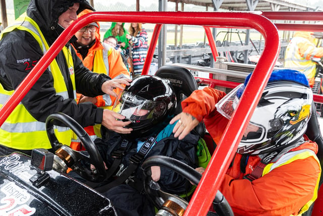 A youngster is fitted for her ride in a kart at Three Sisters circuit