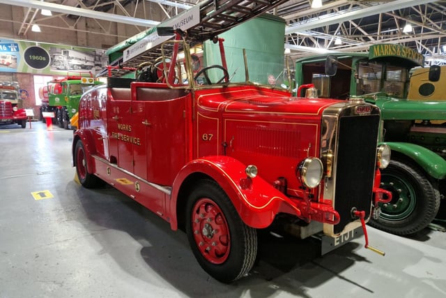 A gorgeous red fire engine from many moons ago