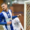 Joe Hugill wheels away after opening his goalscoring account for Latics at Tranmere