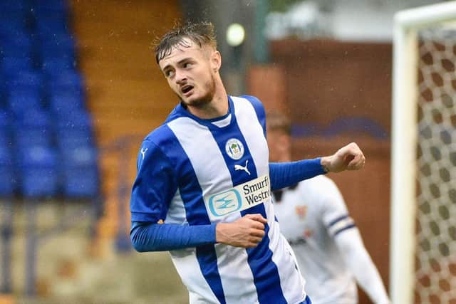 Joe Hugill wheels away after opening his goalscoring account for Latics at Tranmere