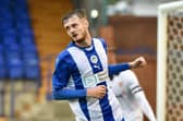 Joe Hugill wheels away after opening his goalscoring account for Latics at Tranmere