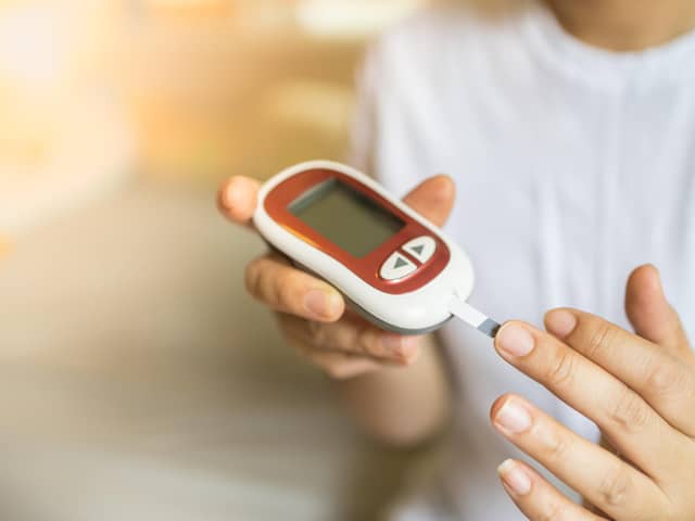 A glucose meter being used to check blood-sugar levels