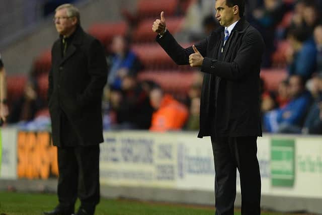 WIGAN, ENGLAND - APRIL 11: Manchester United manager Sir Alex Ferguson looks on as Wigan manager Roberto Martínez gestures during the Barclays Premier League match between Wigan Athletic and Manchester United at the DW Stadium on April 11, 2012 in Wigan, England. (Photo by Michael Regan/Getty Images)