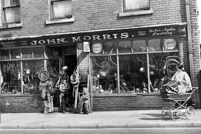 John Morris, aged 88, sat in the doorway of his hardware and cycle shop which he had run for 70 years in Bryn Street, Ashton, in May 1972.