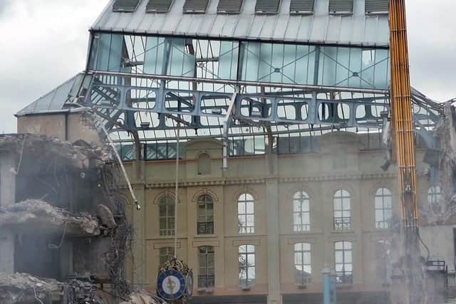 The moment the old Galleries central atrium roof and clock come crashing down as demolition continues.  Stills taken from video by Wigan Watch.