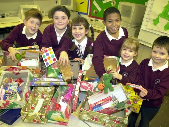 Pupils from Parbold Douglas with some of the charity shoebox collections.
