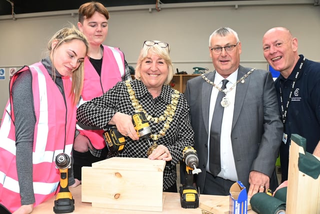 The Mayor of Wigan Coun Marie Morgan with learners and tutors, as they teach the Mayor how to make a birdbox at the official launch of Wigan Training Centre, part of the Growth Company Education and Skills.