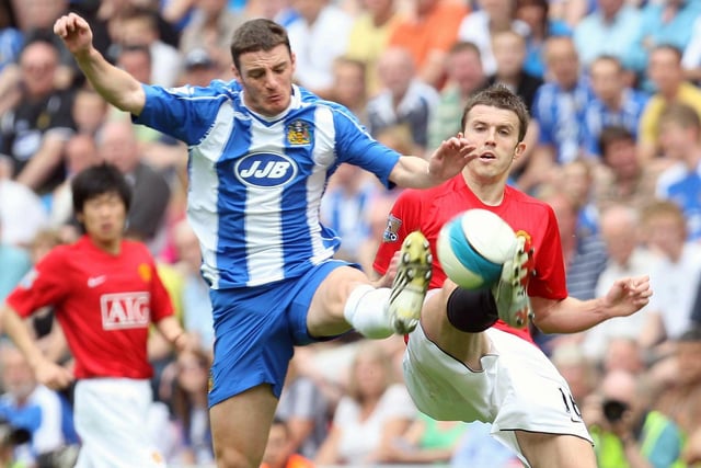 Michael Carrick of Manchester United clashes with Jason Koumas of Wigan Athletic during the Barclays FA Premier League match between Wigan Athletic and Manchester United at JJB Stadium on May 11 2008, in Wigan, England.
