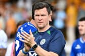 Gary Caldwell salutes the travelling Latics fans at Cambridge