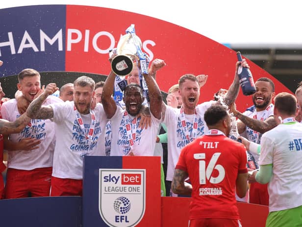 The Latics players celebrate their title success