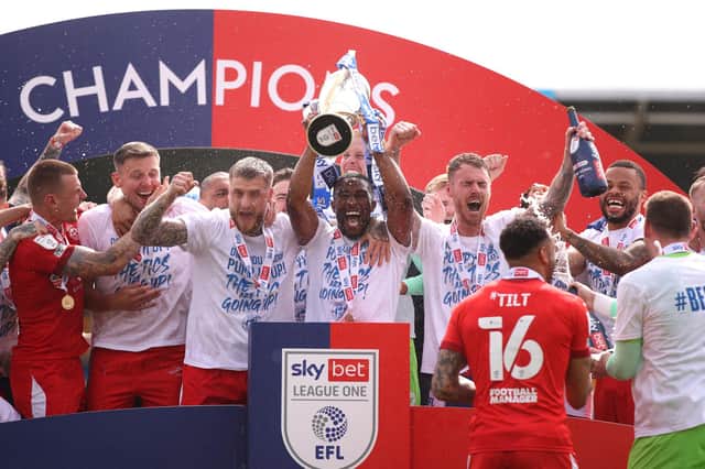 The Latics players celebrate their title success