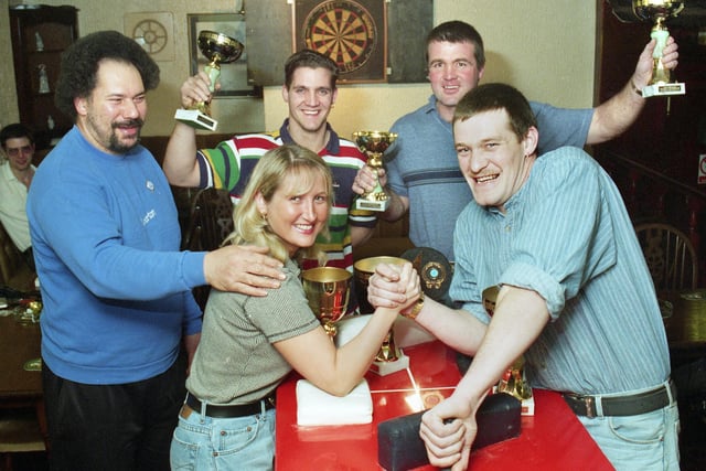 Arm wrestling competitors with trophies at the Alexandra Hotel, Whelley, in January 1997.