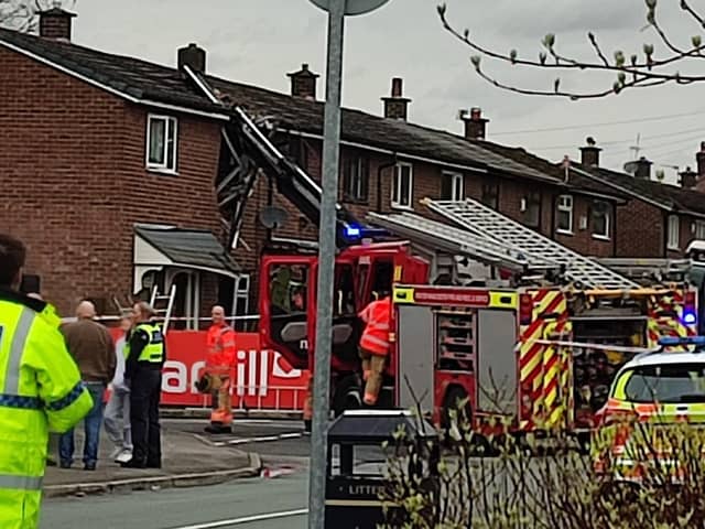 Emergency services at the house on Flapper Fold Lane, Atherton, which was hit by a crane. Picture by Dave Dutton