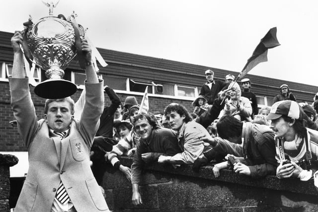 After the heartbreak of losing at Wembley in 1984, a relieved Shuan Edwards holds aloft the Challenge Cup for the fans at Central Park at the homecoming.
