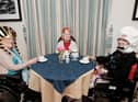 Residents Violet Huddard, June Hope and Sylvia Heys enjoying their history themed afternoon tea together