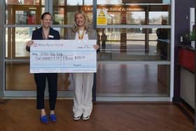 Headteacher Jen Evans is pictured presenting a cheque to Leah Wegener of Cash for Kids