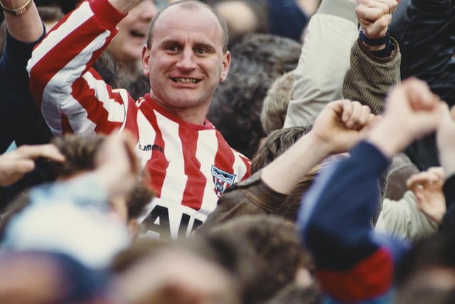 A Sunderland fan celebrates his side's goal whilst holding a cigarette during a match against Newcastle United at St James' Park on February 4, 1990.