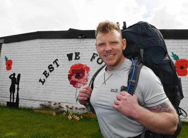Royal Marine Commando veteran Mark Snape setting off on on his 70-mile trek, carrying up to 60lb (27.2kg) of kit, from Wigan Armed Forces Community HQ.