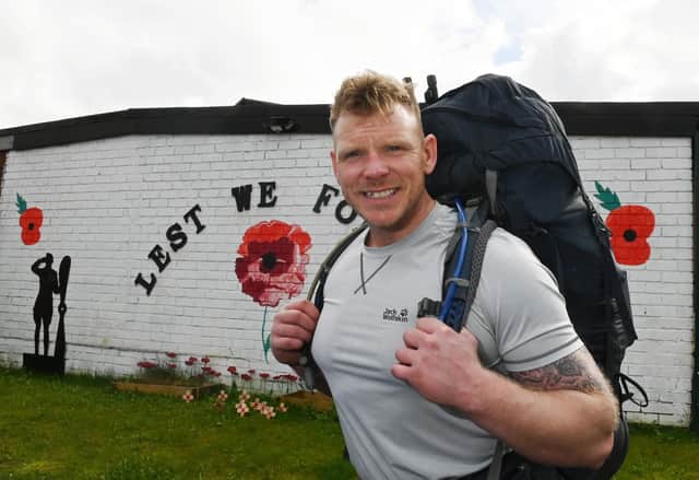 Royal Marine Commando veteran Mark Snape setting off on on his 70-mile trek, carrying up to 60lb (27.2kg) of kit, from Wigan Armed Forces Community HQ.