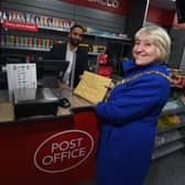 The Mayor of Wigan Coun Marie Morgan, right, is the first customer at the new Wigan Post Office, pictured with postmaster Arif Matadar
