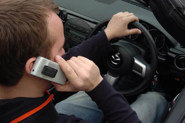 Penalties for phoning while driving have got tougher. Picture posed by a model