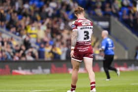 Adam Keighran of Wigan walks from the field after being shown a red card