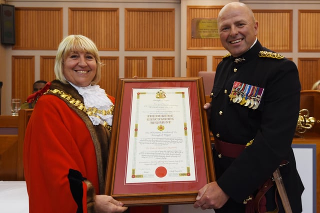 The Mayor of Wigan Coun Marie Morgan, left, makes a presentation to The Duke of Lancaster Regiment Colonel -  Brigadier Frazer Lawrence OBE, right.