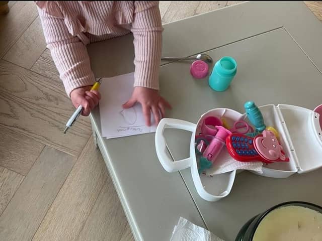 I encourage imaginative play with prompts. Here little one is writing a prescription for baby.