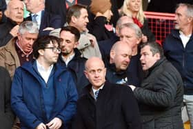 Ben Goodburn (front row, centre) will continue to balance the roles of Latics chairman and interim CEO