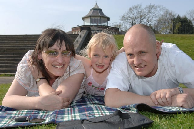p3
SUN, glorious sun! Rebecca Jones, five, of Park Road, gets in some sunbathing in what she calls her 'front garden' - Mesnes Park - with mum and dad Sharon and Glynn during the warm weather.  (NF)
