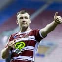 Wigan's Harry Smith thanks the fans for their support after victory over Huddersfield