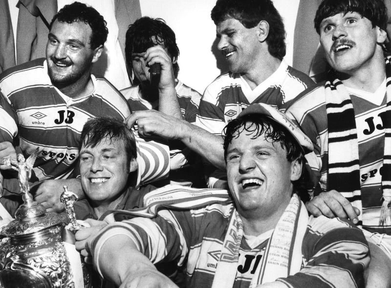 Wigan players celebrating in the Wembley dressing room after beating Hull in the 1985 final are physio, Keith Mills and Brian Dunn, Back, left to right, Brian Case, Nick du Toit and Ian Potter.