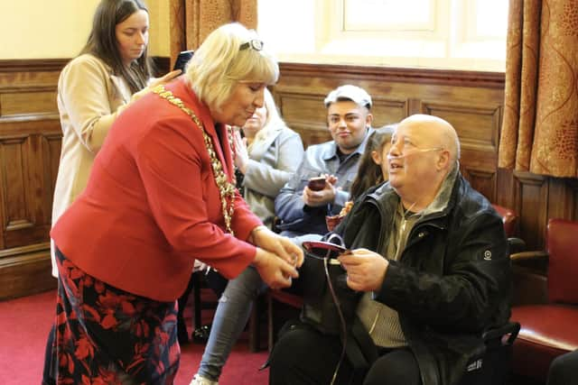 Dave Grundy receives the Heart of the Community award from Mayor of Wigan Coun Marie Morgan